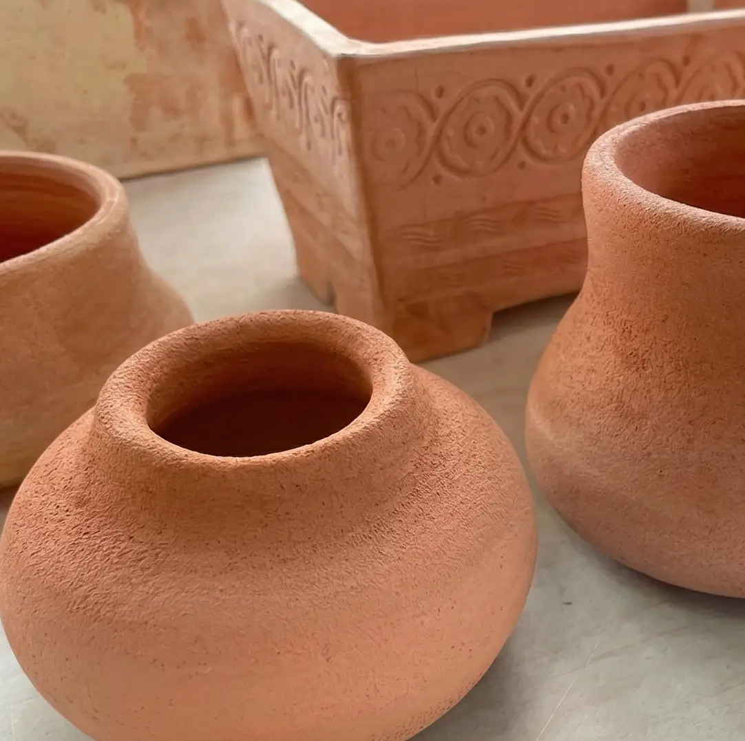 Close-up detail of a textured wild clay vessel corner.