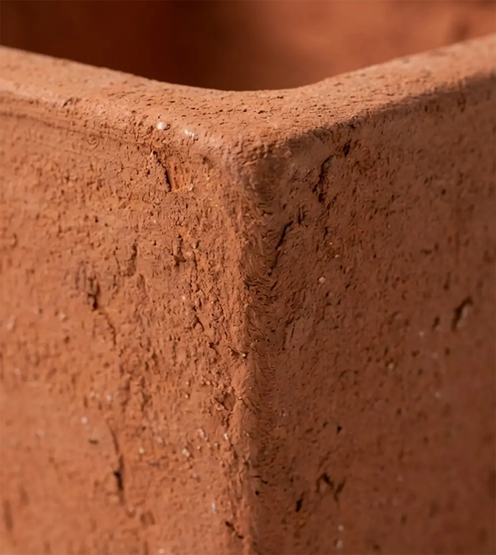 A collection of hand-formed bisqued ceramic pots in various shapes.